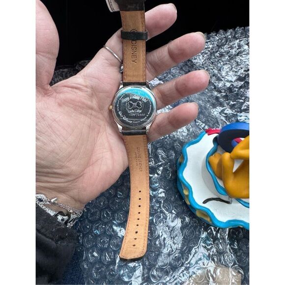 Pluto\'s 70th Birthday watch and sculpture.
